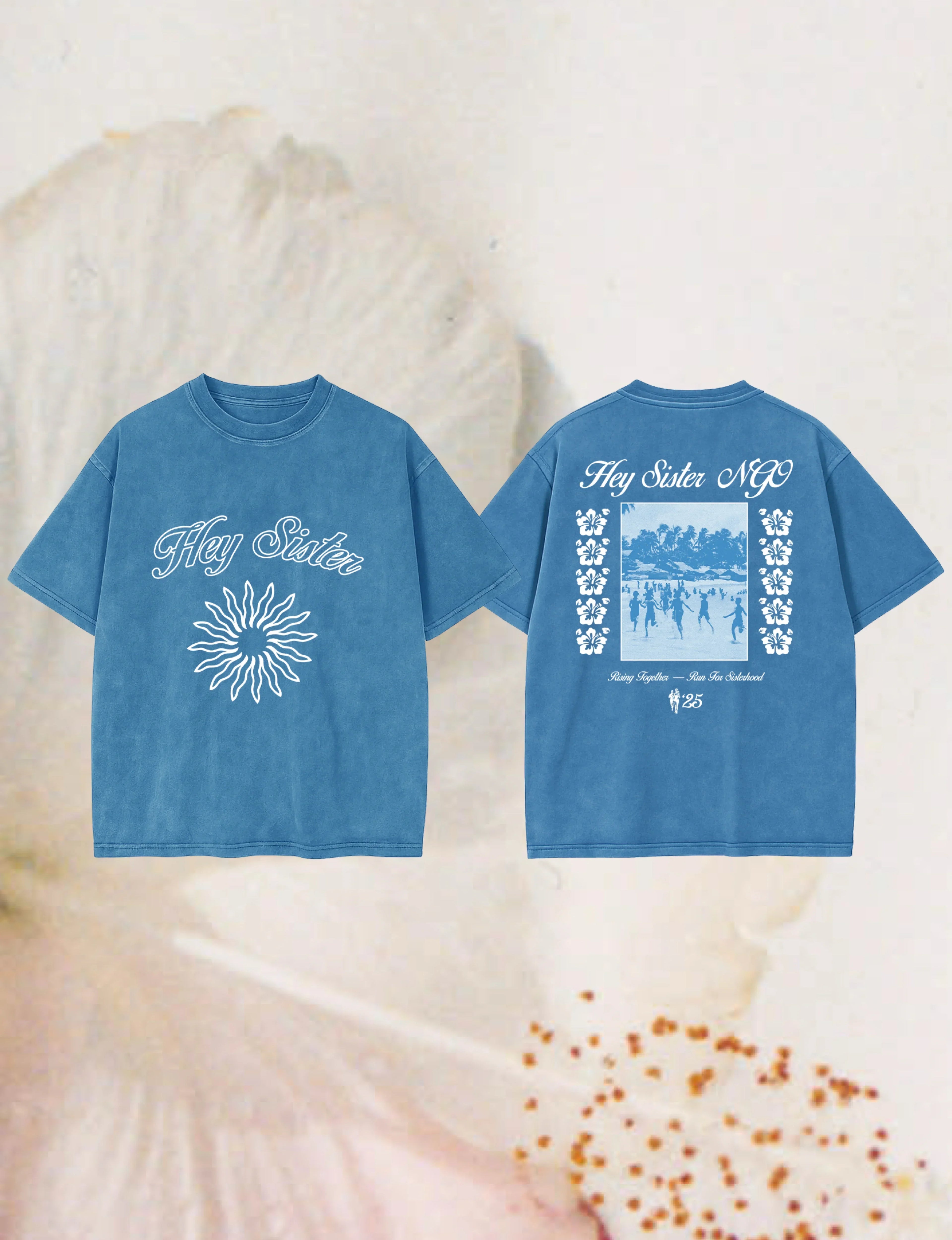 Blue Hey Sister NGO T-shirt with white text and sun design front, group running photo and floral prints on back